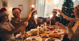 Ein Gruppe von Menschen feiert zuhause gemeinsam das Weihnachtsfest